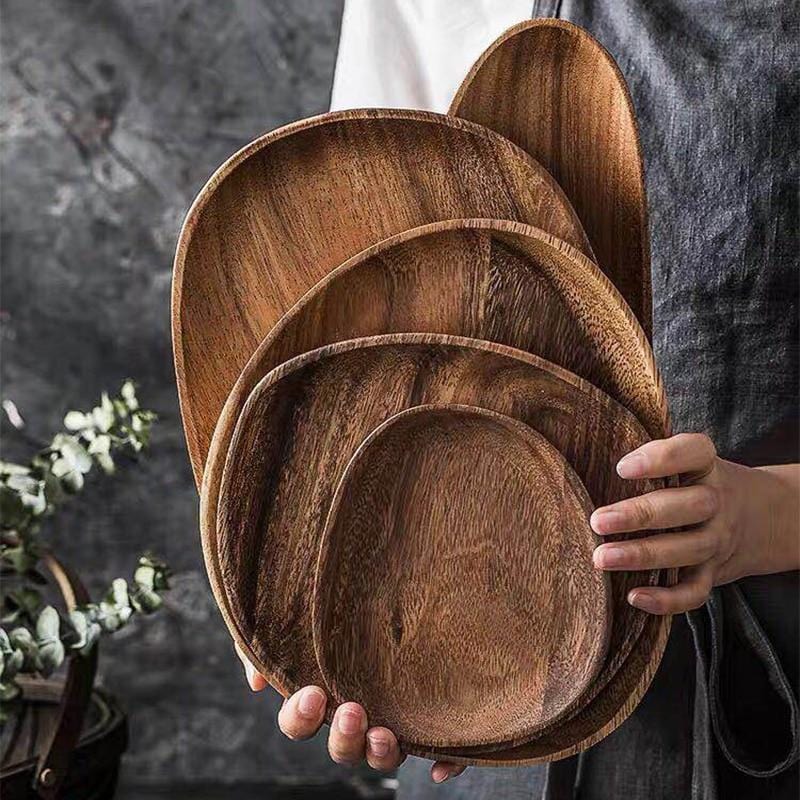 Natural Acacia wood trays stacked in hand
